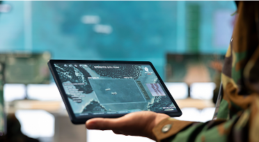 A soldier looking at radar on a tablet